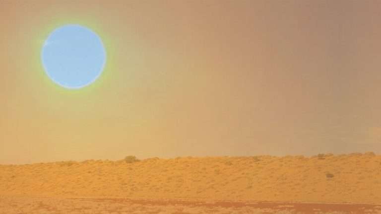 Orange sun over desert